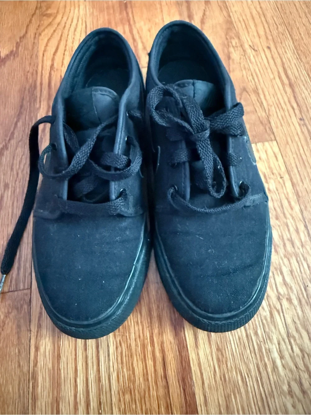 Nike Toki Low Triple Black canvas colorway (model number 555272-015) sneakers 4Y